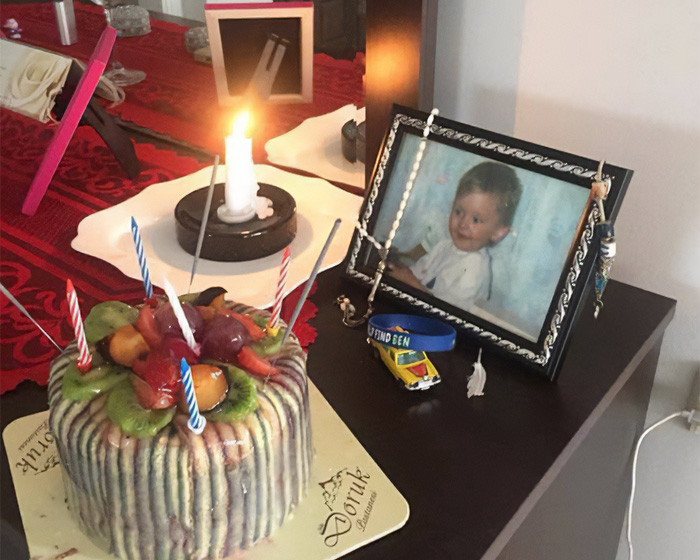 Memorial setup with candle and photo of missing child