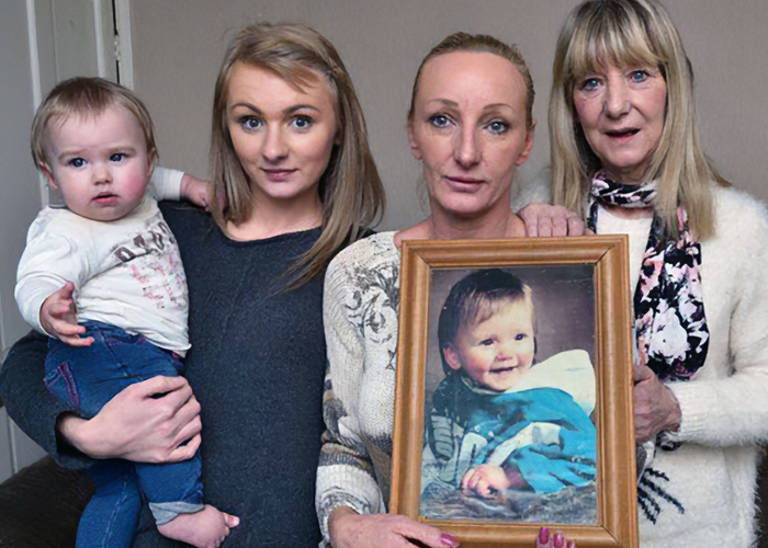 Group photo with family holding missing child photo