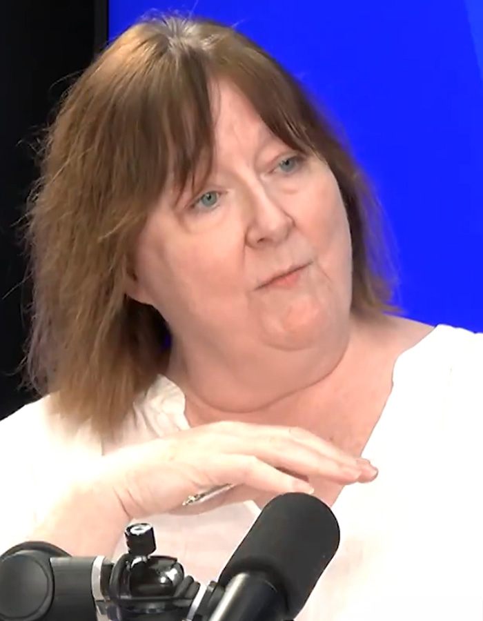 Older woman reacting during a podcast interview with Bonnie Blue