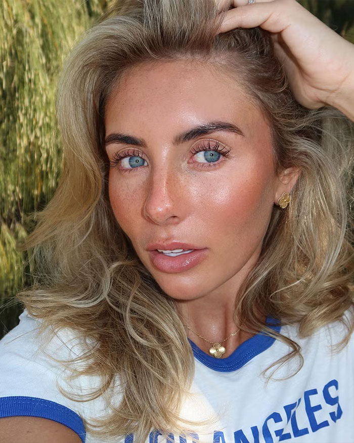 Close-up portrait of Bonnie Blue with blonde hair and blue eyes outdoors