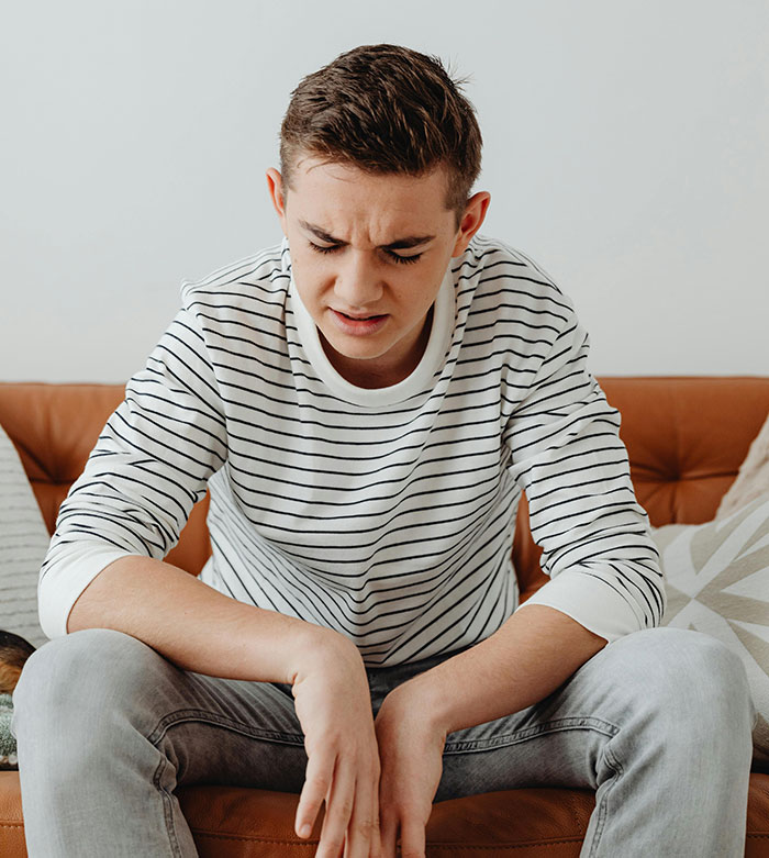 A young man with a distressed expression, representing the challenges of a blended family that destroyed his happiness.