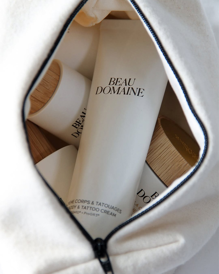 Beau Domaine skincare products inside a white zippered bag