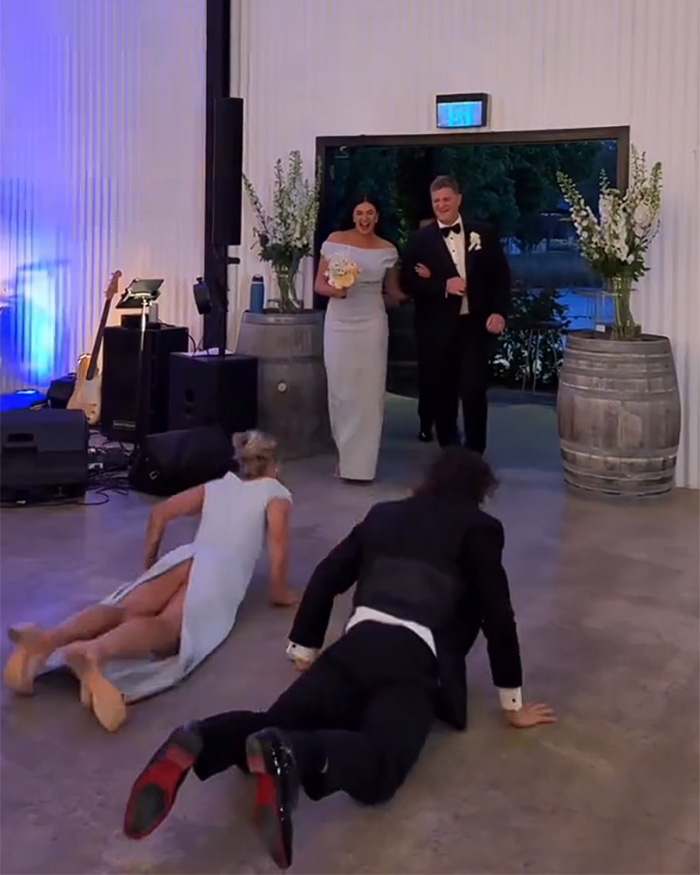 Bridesmaid and partner fall during reception dance at wedding