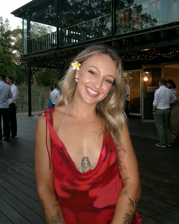 Smiling bridesmaid in red dress at wedding reception venue