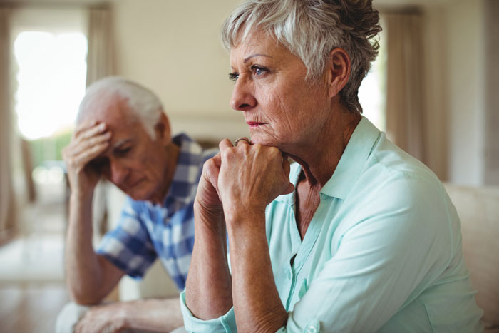 A worried older couple, possibly contemplating issues like brother wedding money or food expenses.