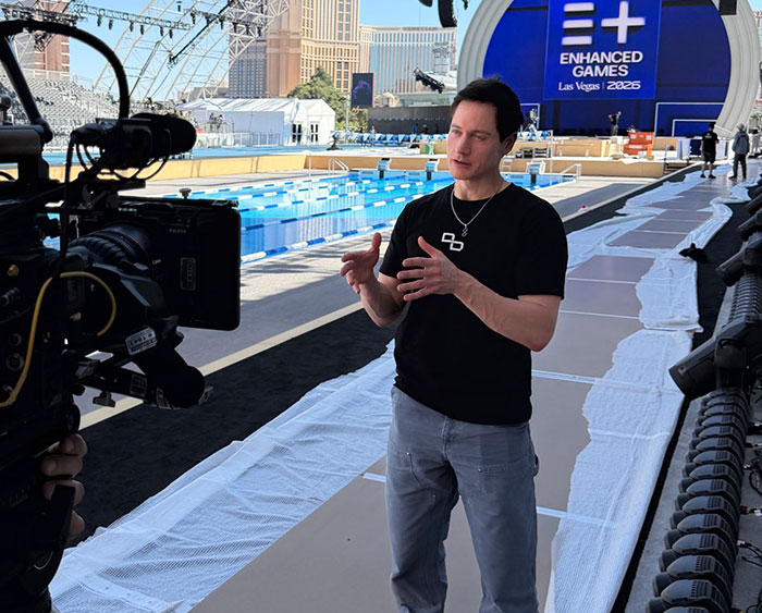 Man being interviewed at Steroid Olympics poolside venue