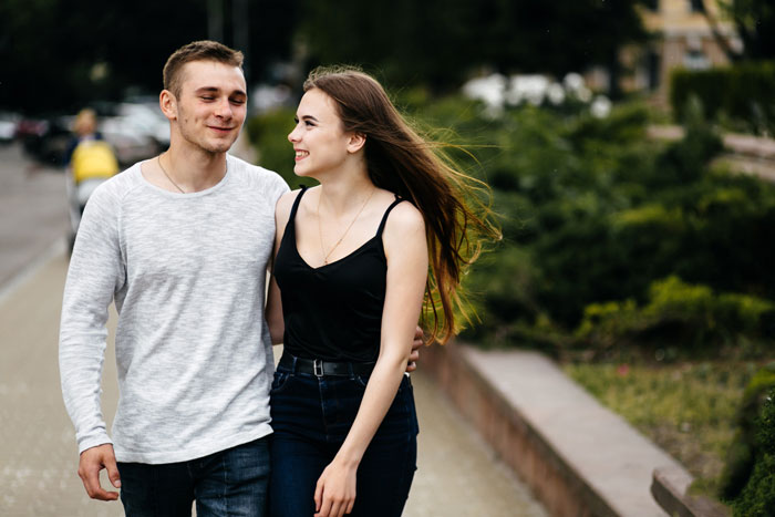 Couple walking smiling outdoors, related to bullying forgiveness story