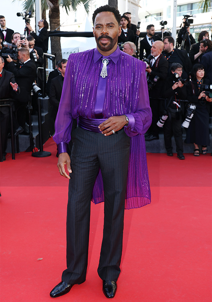 Man in purple sequin shirt and pinstripe trousers on Cannes red carpet