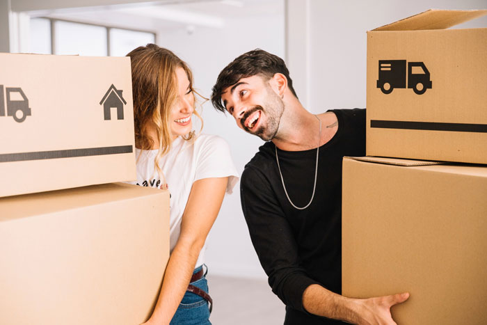 Happy couple moving boxes, perhaps replacing old items. Not with clowns, but a fresh start for a fianc&eacute;e.