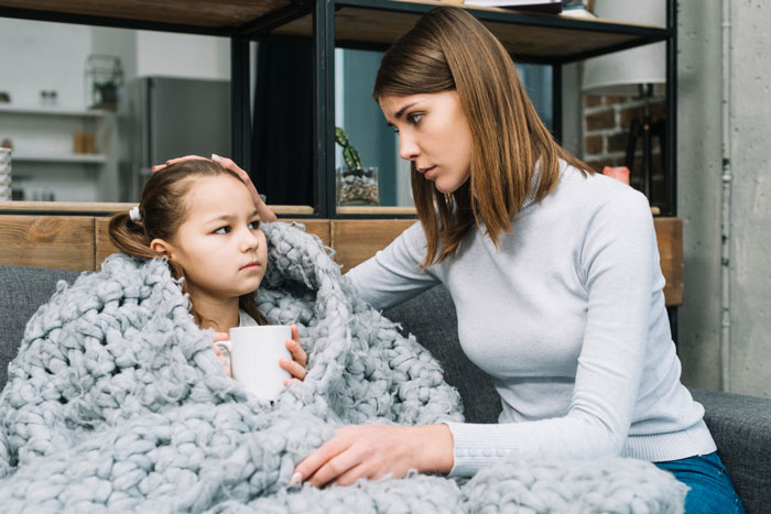Mother comforting daughter wrapped in blanket after dog attack recovery Mother comforting daughter wrapped in blanket after dog attack recovery