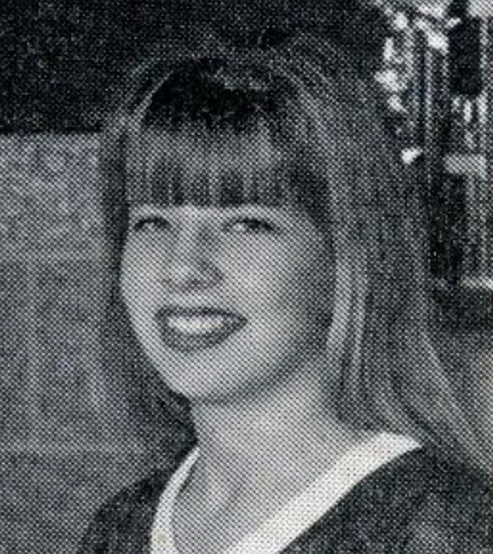 Old black-and-white photo of young woman with bangs smiling Old black-and-white photo of young woman with bangs smiling