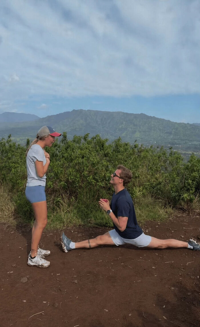 A man proposes to a woman doing the splits on a hiking trail. Hilarious edits of this proposal pic.