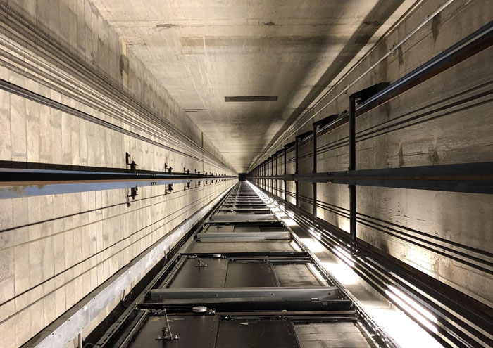 Looking up in elevator shaft conveying deep perspective on passing away moments