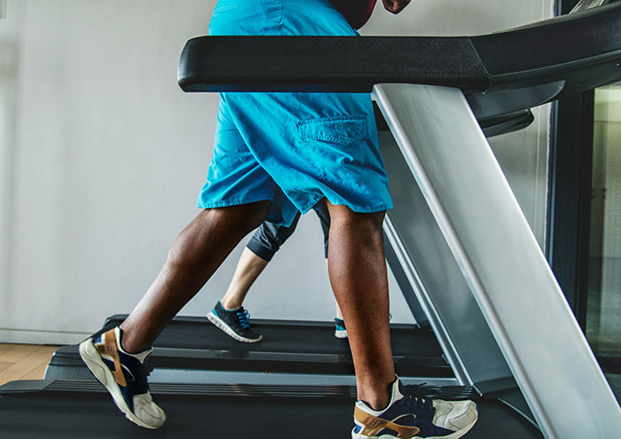 Closeup of legs walking on treadmill illustrating fitness amid passing away concerns