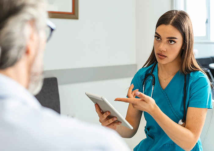 Nurse discussing close and creepy passing away encounters with elderly patient