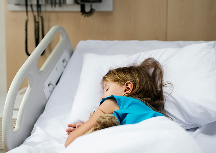 Child sleeping in hospital bed after closest and creepiest passing away experience