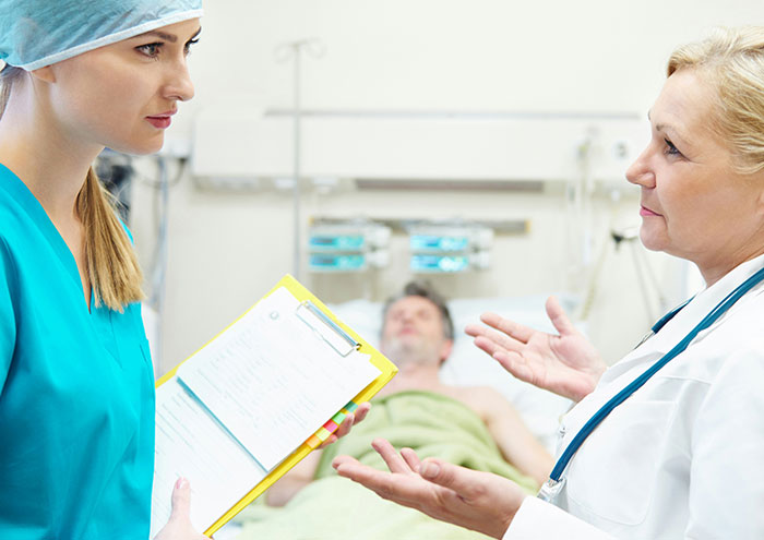 Doctors consulting in hospital near patient about closest and creepiest encounters with passing away