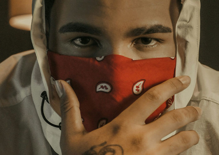 Man with red bandana covering face reflecting close and creepy encounters with passing away