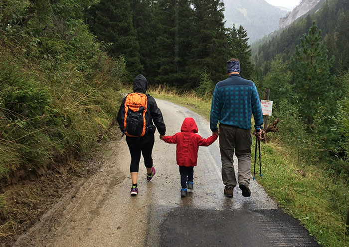 Family walking in forest during reflective moment on closest and creepiest passing away encounters