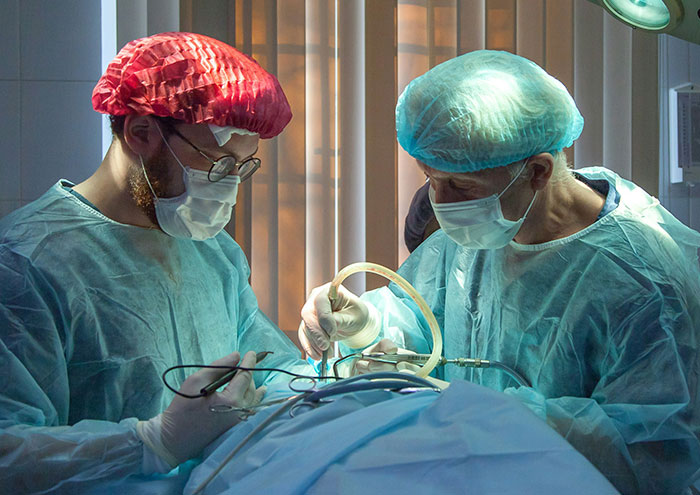 Surgeons performing operation in sterile room during closest encounters with passing away