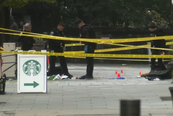 Crime scene with police officers and yellow tape near Starbucks after violent incident