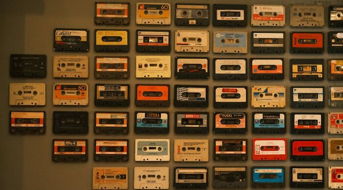 Wall display of vintage cassette tapes representing 80s pop culture and music nostalgia collection Wall display of vintage cassette tapes representing 80s pop culture and music nostalgia collection