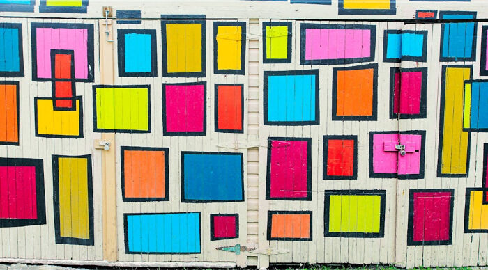 A vibrant wall mural with rectangular shapes in various bright colors, evoking pop culture aesthetics. A vibrant wall mural with rectangular shapes in various bright colors, evoking pop culture aesthetics.