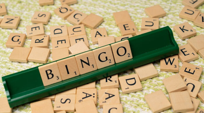 Scrabble tiles spelling bingo amidst scattered letter tiles for puzzle and word game Scrabble tiles spelling bingo amidst scattered letter tiles for puzzle and word game