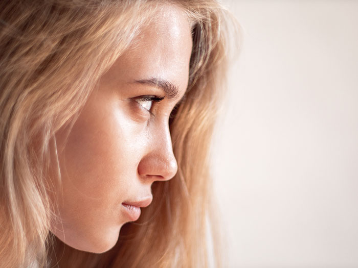 Close-up of serious woman staring intensely related to creepy things women have done