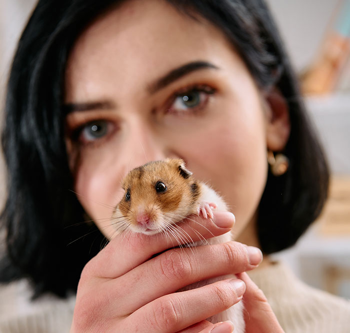Woman holding a hamster close-up, representing creepy things women have done to men