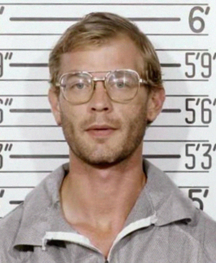 Mugshot of a man in front of height measurement wall for serial killers facts