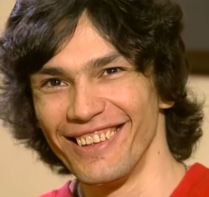 Young man smiling in a photo connected to shocking facts about serial killers