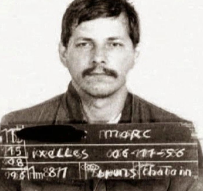 Black and white mugshot of a man holding prison identification board serial killers facts