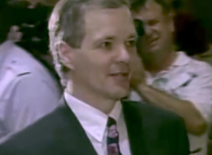 Man in suit at a public event related to serial killer case