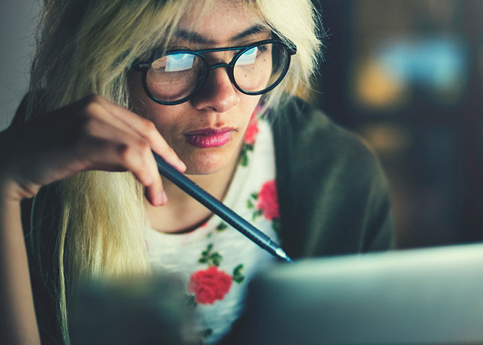 Woman analyzing laptop screen uncovering darkest secrets accidentally discovered