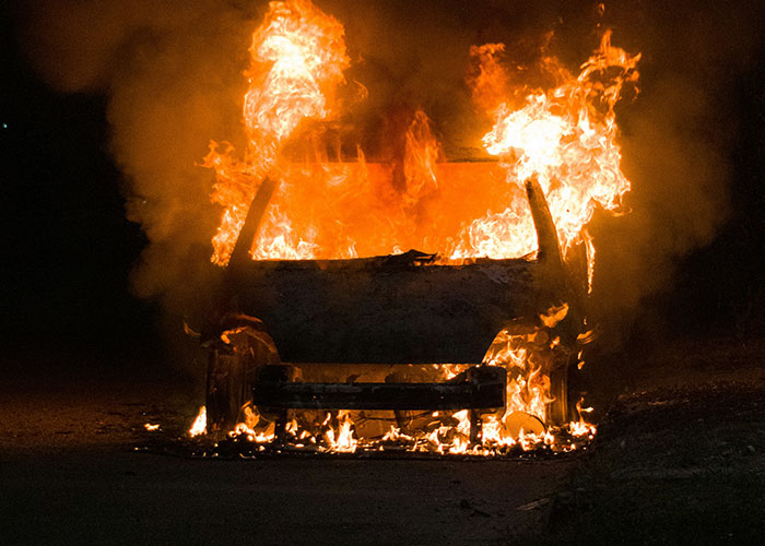 Car engulfed in flames representing darkest secrets exposed
