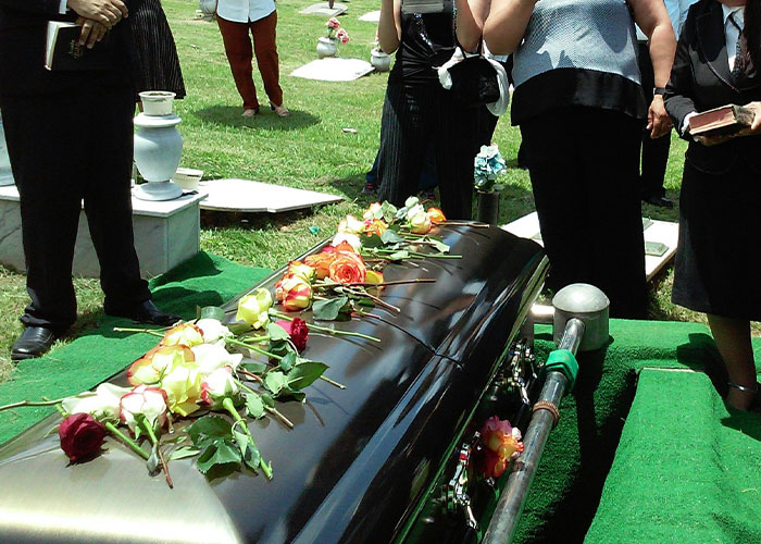 Funeral with flowers on coffin symbolizing dark secrets revealed