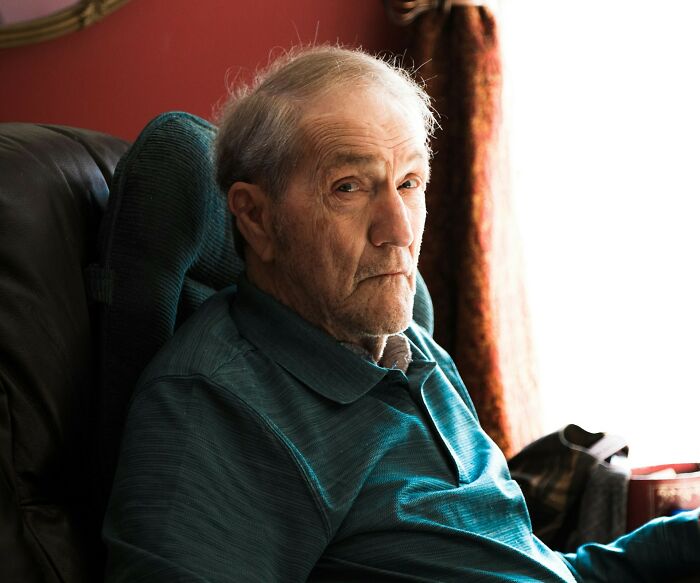 An elderly man with white hair looking intently at the camera, showcasing epic comebacks with his expression.