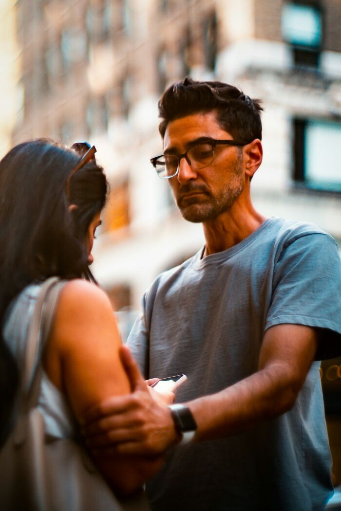 Man looking serious while talking to woman in urban situationship scene