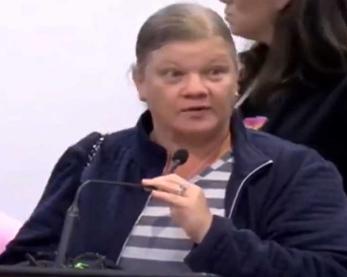 Woman speaking at microphone about Christian mom's double life Woman speaking at microphone about Christian mom's double life