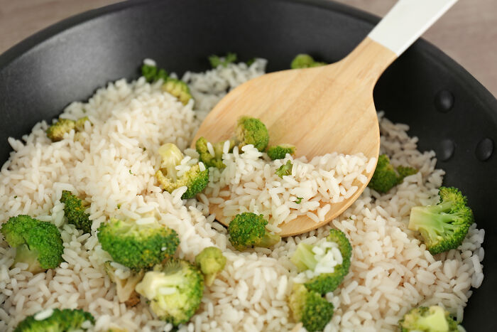 Cooked rice with broccoli in pan for budget poverty meals