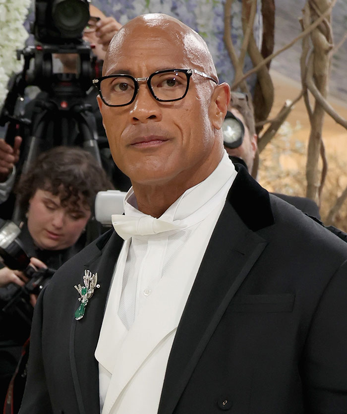 Dwayne The Rock Johnson at Met Gala 2026. A black tie look with plastic surgery focus.