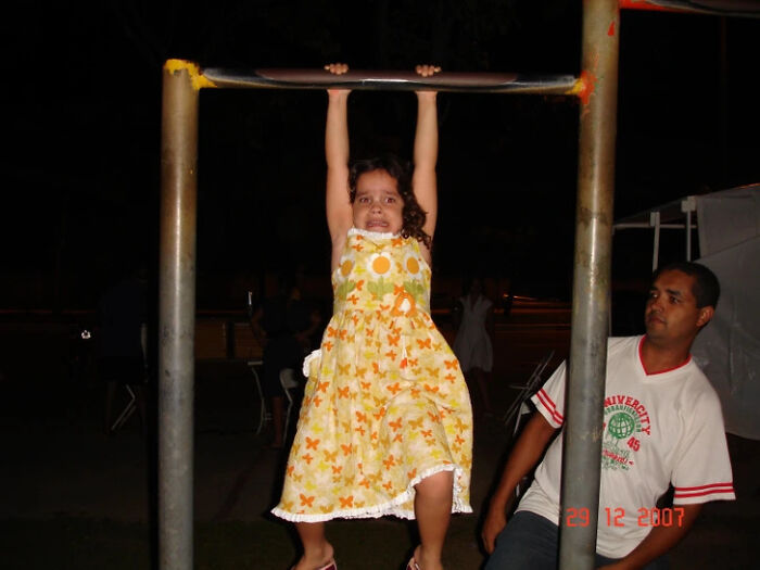 Cringe fail of girl struggling to hang on monkey bars at night