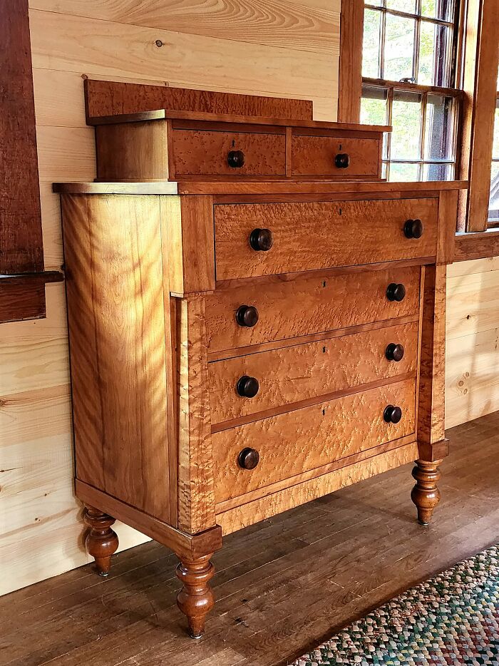Historic American dresser with curly maple wood, showcasing classic craftsmanship for collectors of early American pieces.