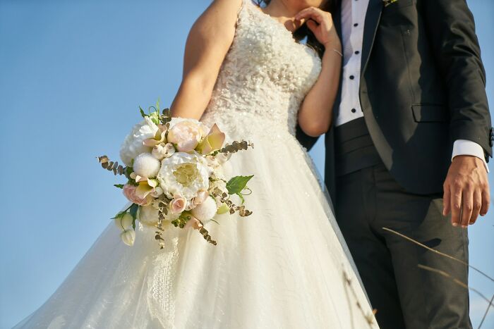 Bride and groom with bouquet symbolizing evil MILs wedding stories