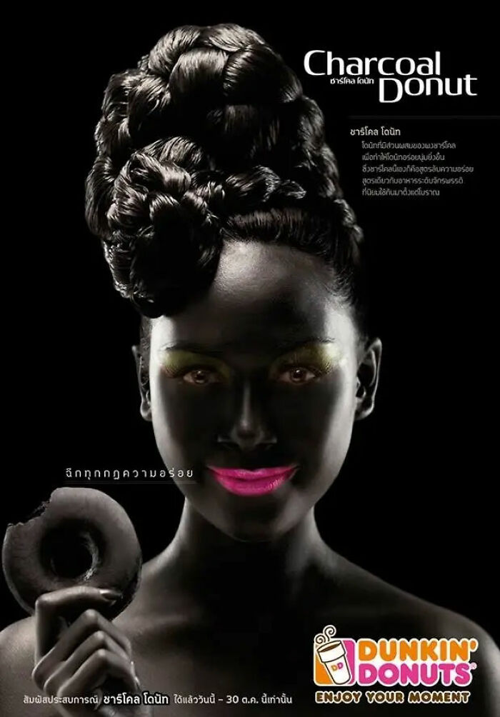 Dunkin Donuts charcoal donut ad with woman holding black donut and styled hair