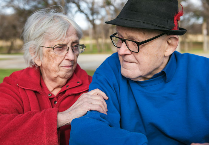 Elderly parents in thoughtful conversation symbolizing parents demanding rich daughter's money Elderly parents in thoughtful conversation symbolizing parents demanding rich daughter's money