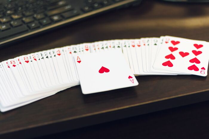 Deck of playing cards fanned out on wooden desk