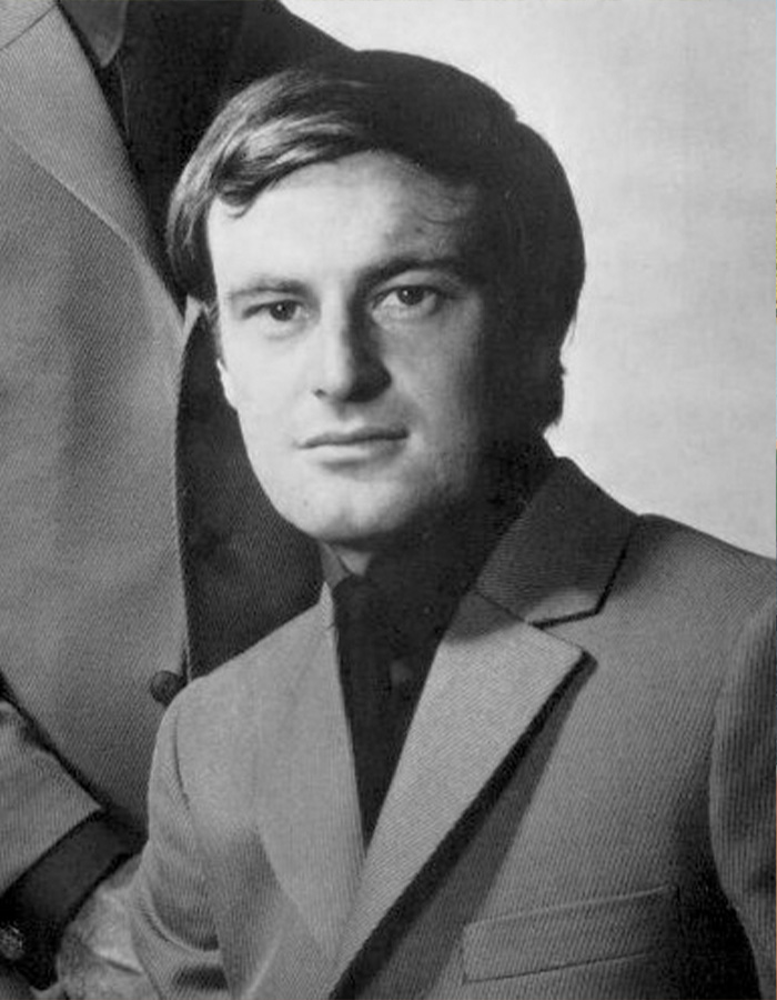 Black and white portrait of a famous man in a suit related to dramatic coming out stories