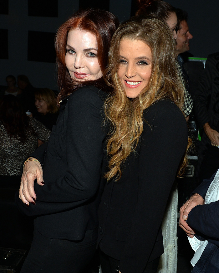 Priscilla Presley and Lisa Marie Presley smiling, embracing in black outfits. Fans slam Priscilla Presley.